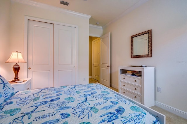 carpeted bedroom with a closet and crown molding