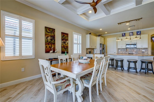 dining area featuring beam ceiling, crown molding, coffered ceiling, and light hardwood / wood-style flooring