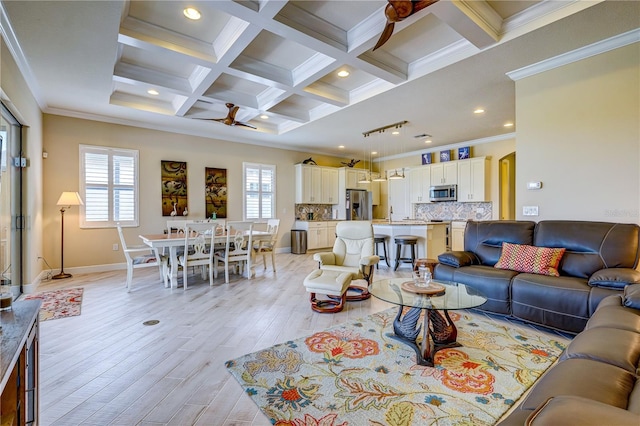 living room featuring ceiling fan, light hardwood / wood-style flooring, crown molding, and a healthy amount of sunlight