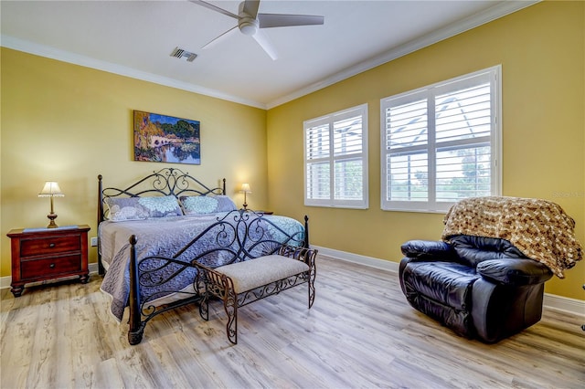 bedroom featuring ceiling fan, crown molding, and light hardwood / wood-style floors