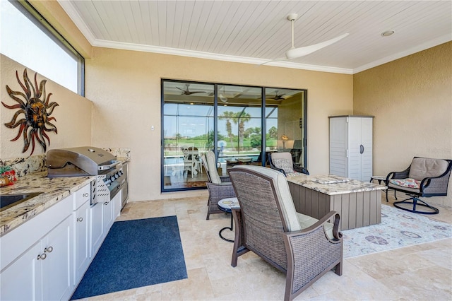 view of patio / terrace featuring exterior kitchen, ceiling fan, and a grill