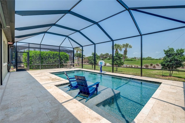 view of pool with a lawn, a patio area, and a lanai