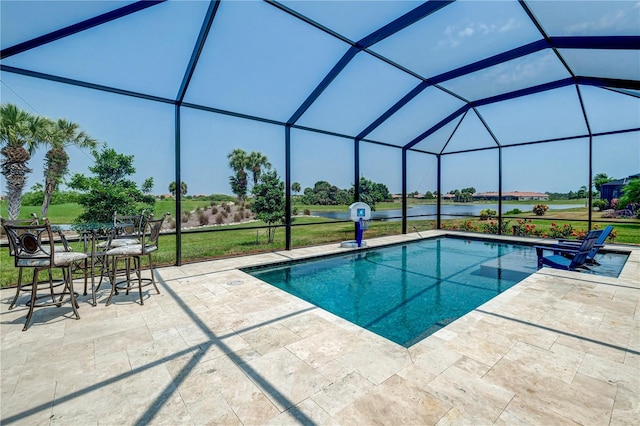 view of pool featuring a water view, a lawn, a lanai, and a patio area