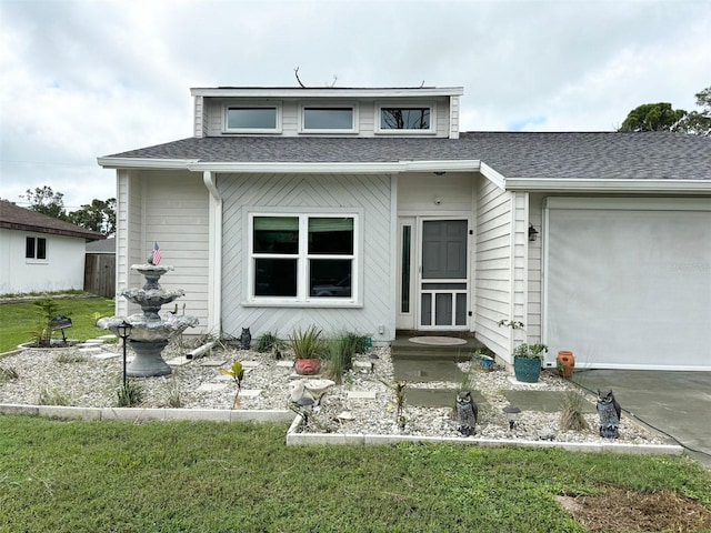 view of front facade with a front yard and a garage