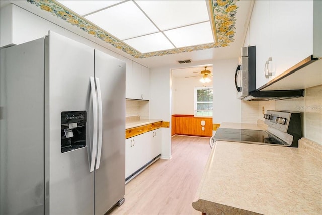 kitchen featuring appliances with stainless steel finishes, decorative backsplash, light hardwood / wood-style floors, white cabinets, and ceiling fan