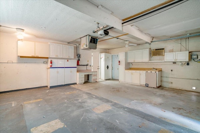 garage featuring a garage door opener and white refrigerator