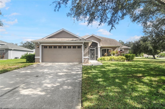 ranch-style house with a garage and a front lawn