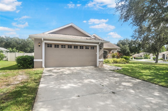 view of front facade featuring a front yard and a garage