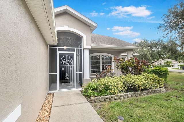 property entrance with a yard