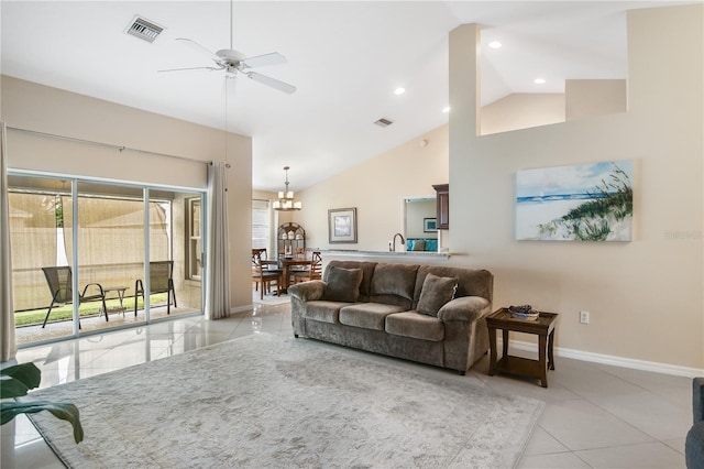 tiled living room with high vaulted ceiling and ceiling fan with notable chandelier