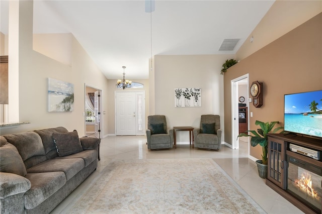 tiled living room with lofted ceiling and a chandelier