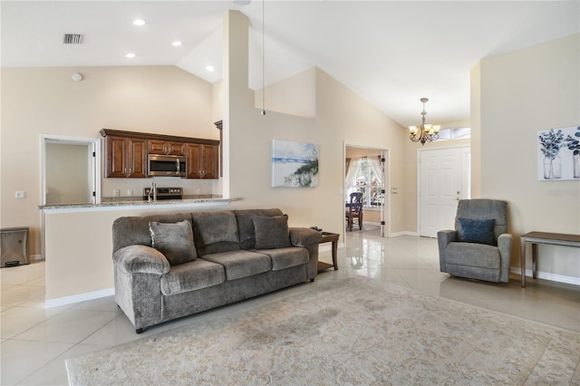 living room featuring an inviting chandelier, light tile patterned flooring, and high vaulted ceiling