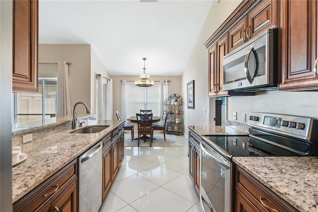 kitchen with sink, stainless steel appliances, lofted ceiling, pendant lighting, and an inviting chandelier