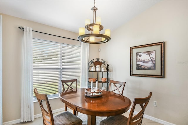 tiled dining room featuring a notable chandelier