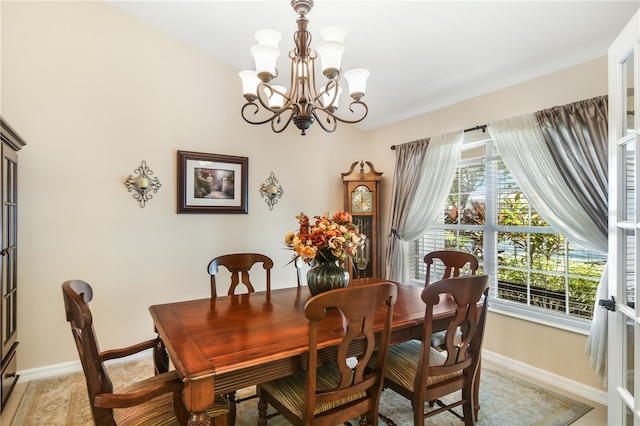 tiled dining area featuring a chandelier