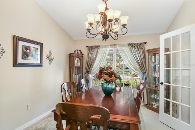 dining room with a notable chandelier and vaulted ceiling