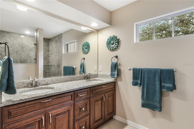 bathroom featuring vanity, tile patterned flooring, and tiled shower