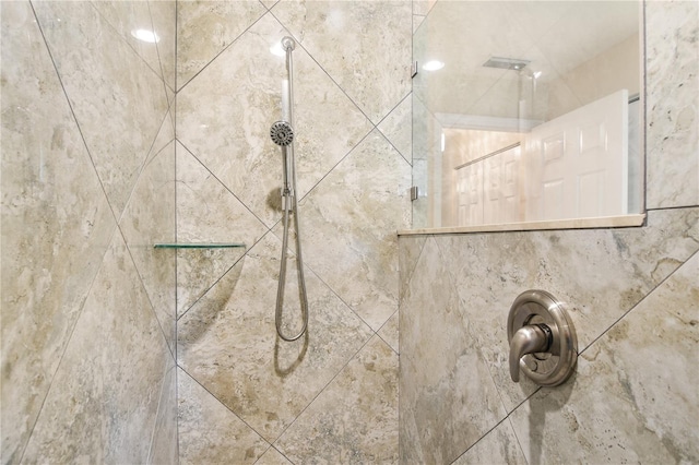 interior details featuring a tile shower