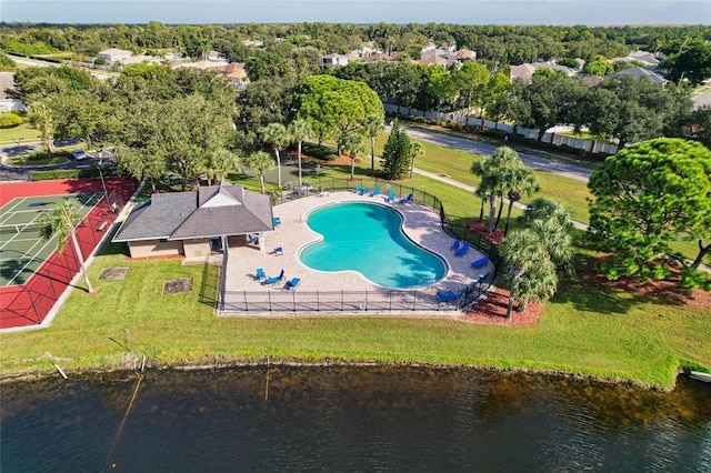 exterior space with a patio, a water view, and a lawn