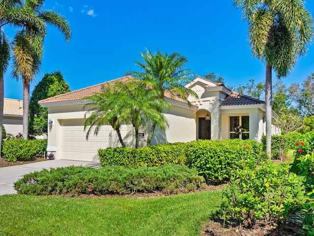 mediterranean / spanish-style home with a garage