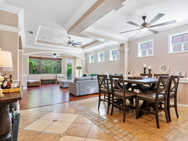 dining area featuring crown molding, ceiling fan, light hardwood / wood-style floors, and a raised ceiling