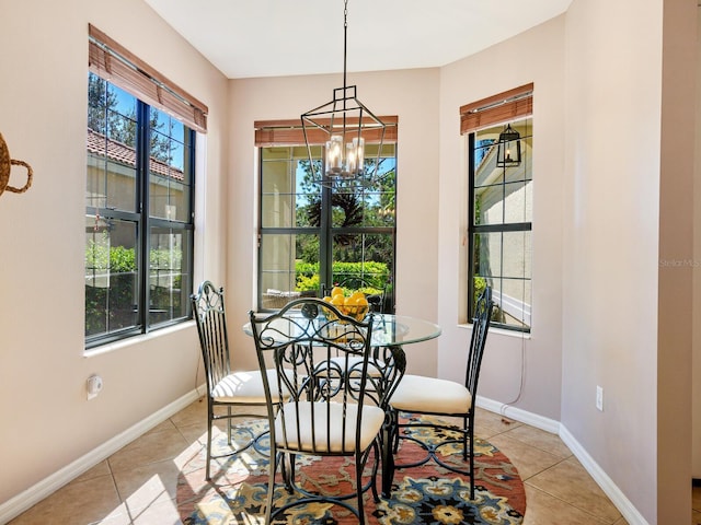 dining space featuring light tile patterned floors and a chandelier