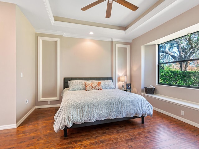 bedroom featuring ornamental molding, a raised ceiling, dark hardwood / wood-style floors, and ceiling fan