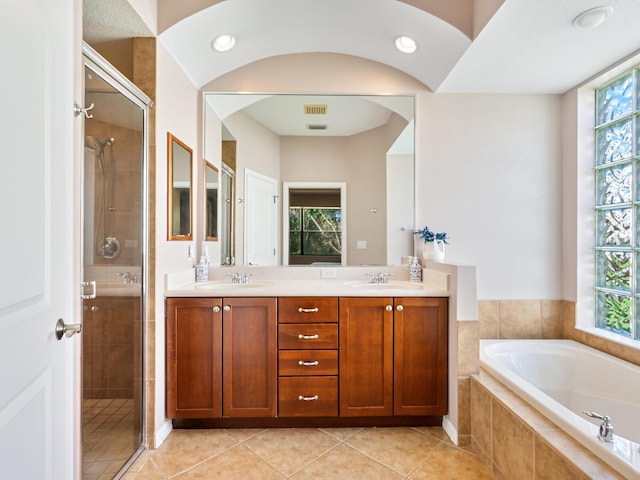 bathroom featuring vanity, independent shower and bath, and tile patterned flooring