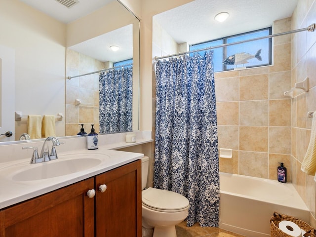 full bathroom with a textured ceiling, toilet, vanity, shower / bathtub combination with curtain, and tile patterned flooring