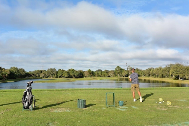 view of property's community featuring a water view and a lawn