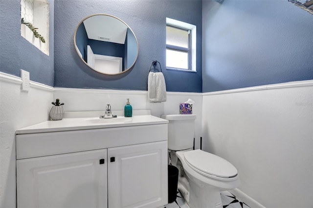 bathroom featuring tile patterned floors, vanity, and toilet