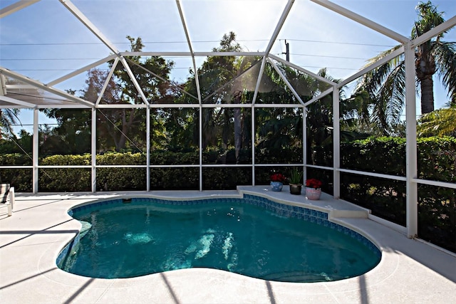 view of pool featuring a lanai and a patio