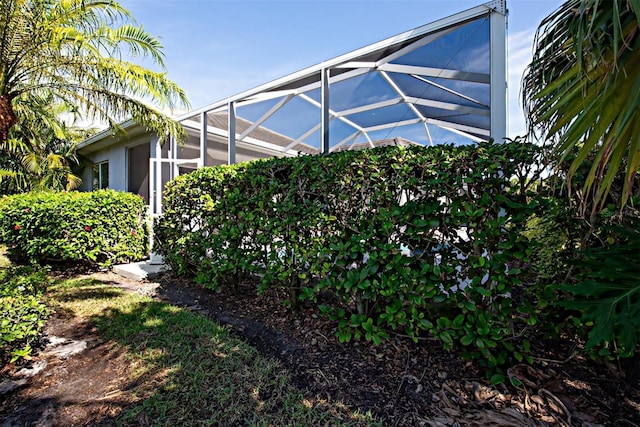 view of yard with glass enclosure