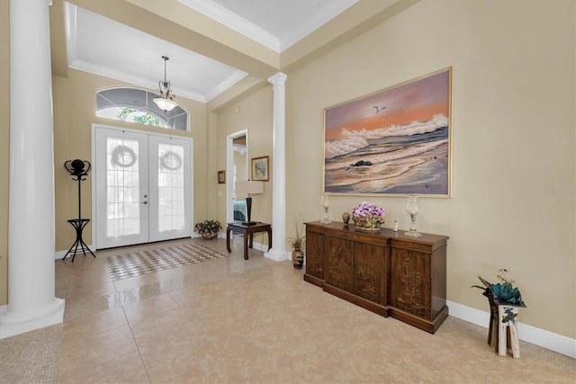 entrance foyer with ornate columns, ornamental molding, light tile patterned floors, and french doors