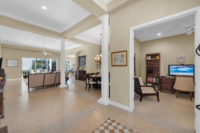 living room with ceiling fan with notable chandelier, ornate columns, ornamental molding, and light tile patterned floors