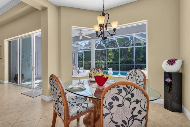 dining room featuring a wealth of natural light, light tile patterned flooring, and a notable chandelier