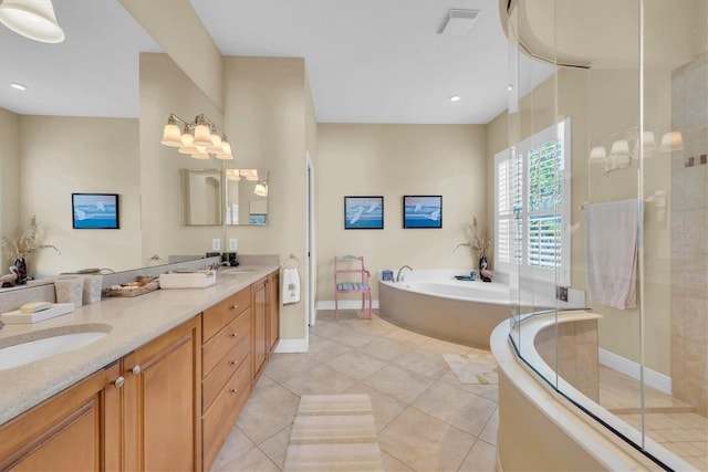 bathroom featuring tile patterned floors, vanity, and plus walk in shower