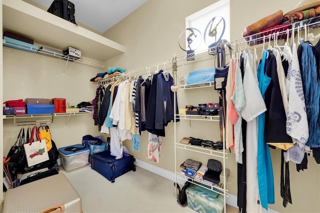 walk in closet with carpet