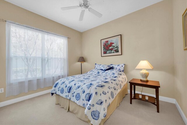 bedroom with light colored carpet and ceiling fan