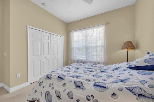 bedroom featuring ceiling fan, a closet, and light carpet