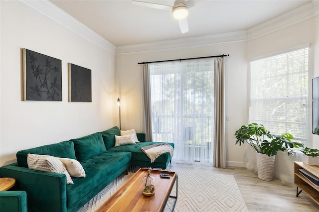 living room featuring ceiling fan, crown molding, and light hardwood / wood-style floors