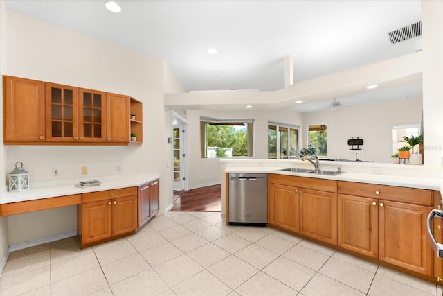 kitchen featuring ceiling fan, dishwasher, sink, kitchen peninsula, and light tile patterned flooring