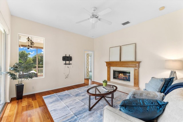 living room with ceiling fan and wood-type flooring