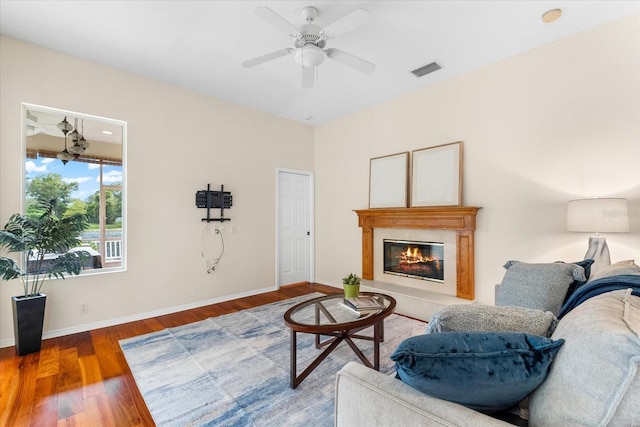 living room with hardwood / wood-style flooring and ceiling fan