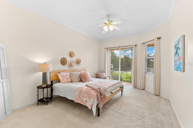 bedroom with ceiling fan, light colored carpet, and crown molding