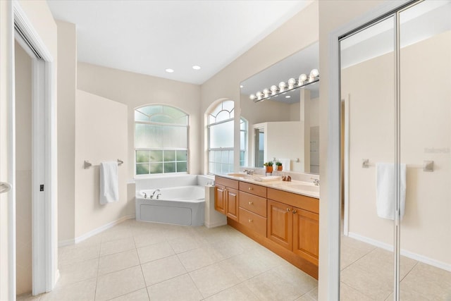 bathroom with tile patterned floors, vanity, and a bathing tub