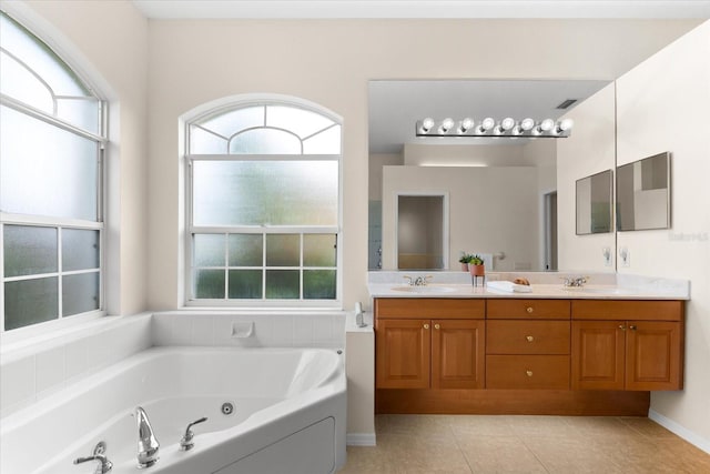 bathroom with vanity, a tub to relax in, and tile patterned floors