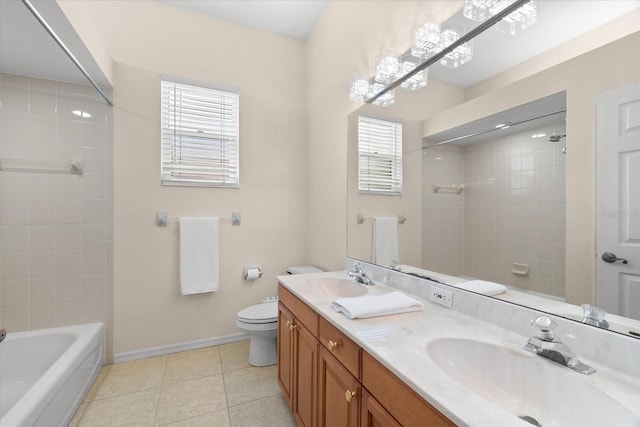 full bathroom featuring tile patterned flooring, vanity, tiled shower / bath combo, and toilet