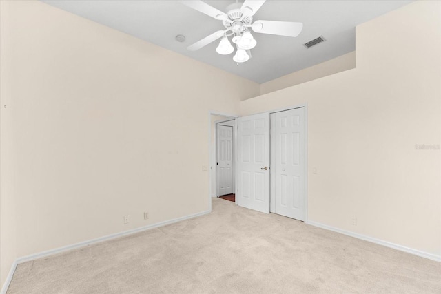 unfurnished bedroom featuring light carpet and ceiling fan