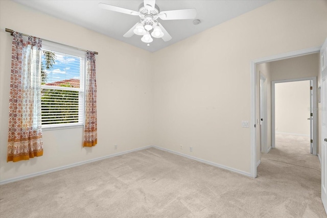 empty room with ceiling fan and light colored carpet